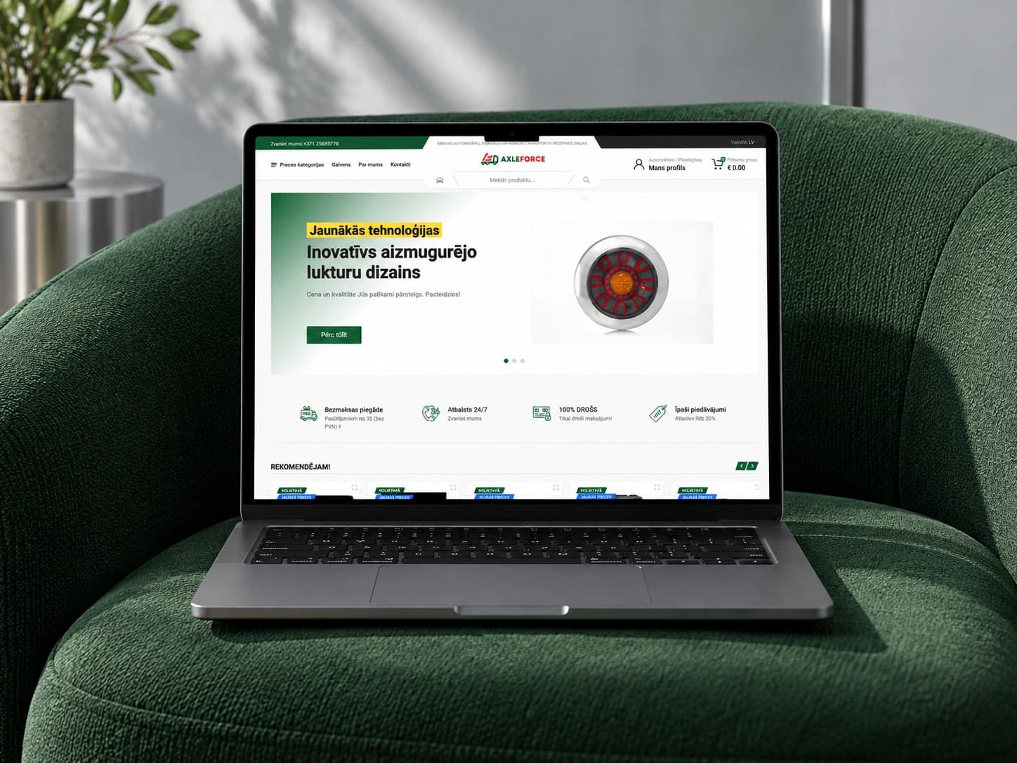 The AxleForce online store homepage on a laptop in a green armchair.