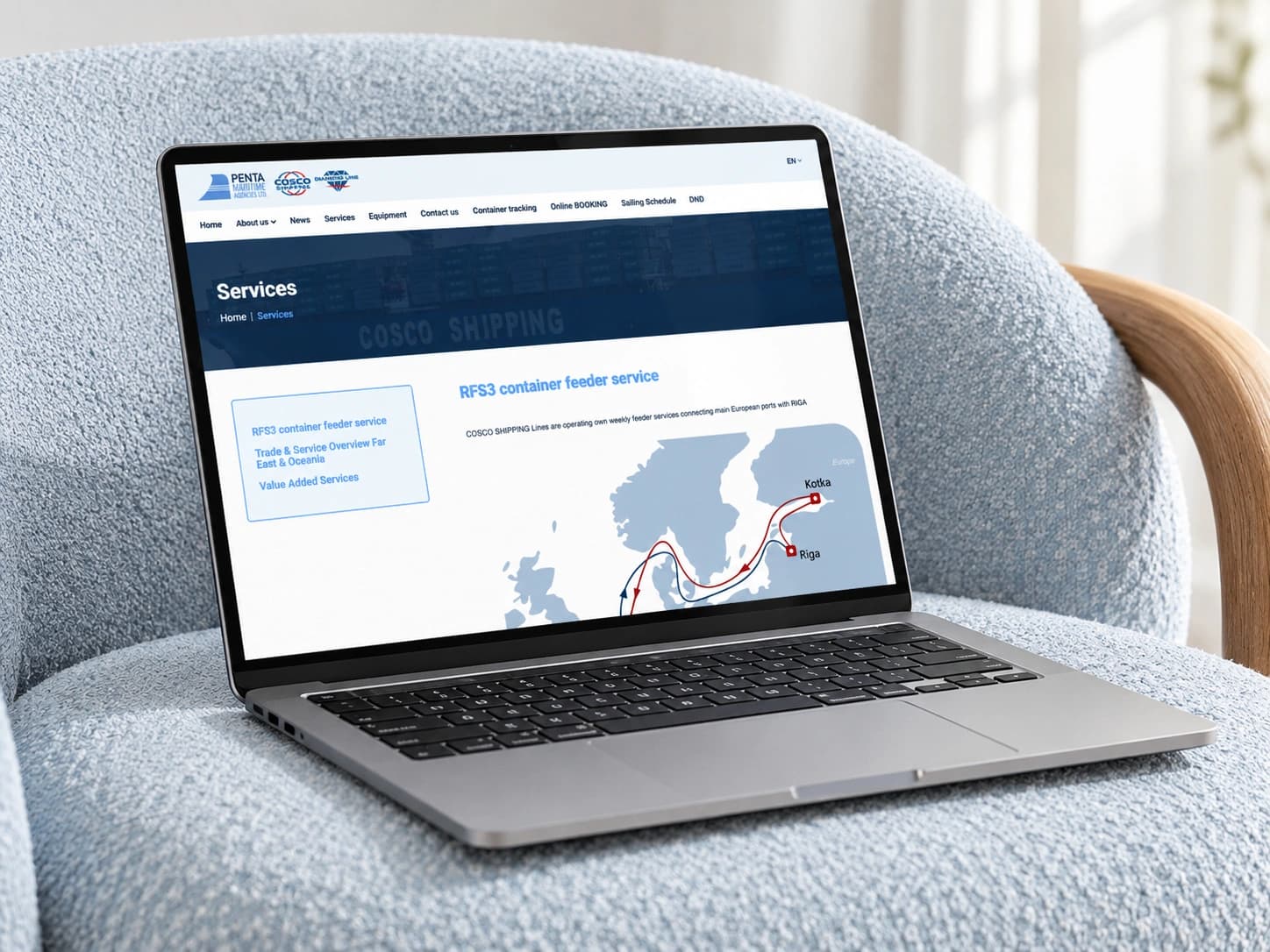 The penta.lv services section on a laptop in a light blue armchair.