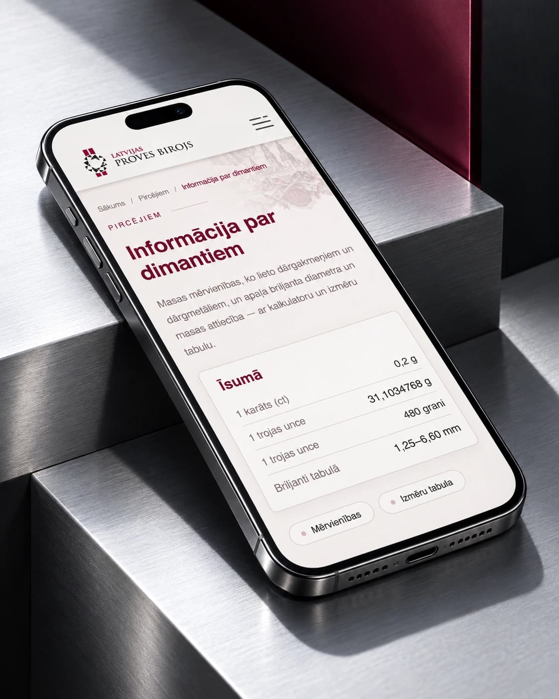 The prove.lv diamond information page on a smartphone on metallic steps.