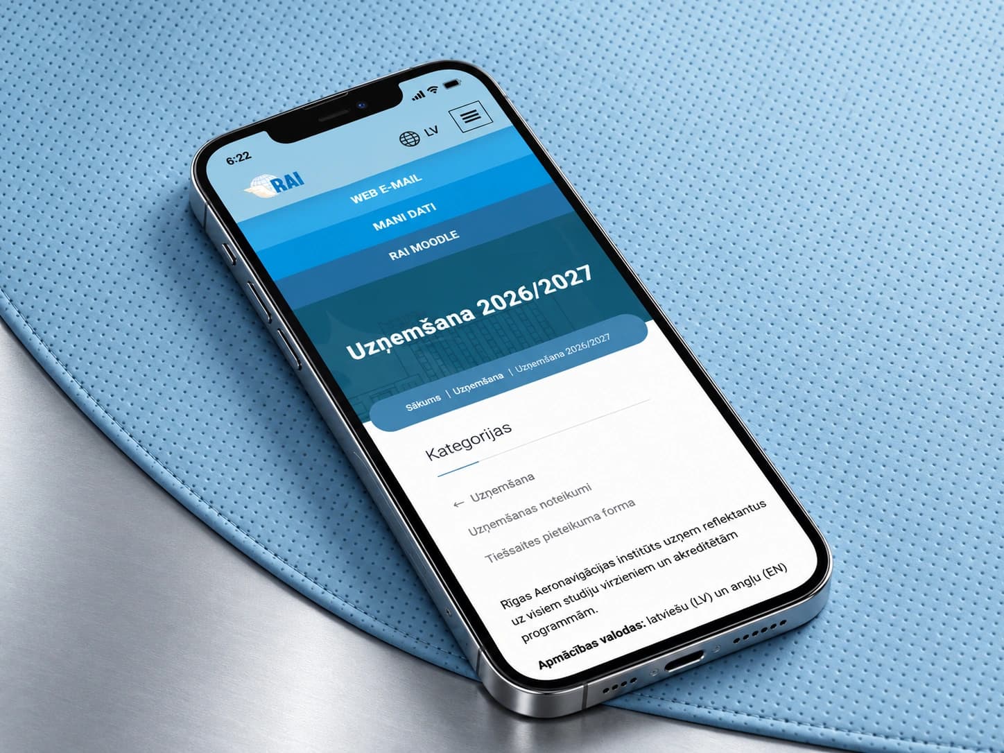 RAI admissions information on a smartphone on a light blue perforated surface.